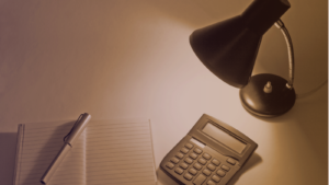Calculator and notebook under a desk lamp — gambling tax in South Africa