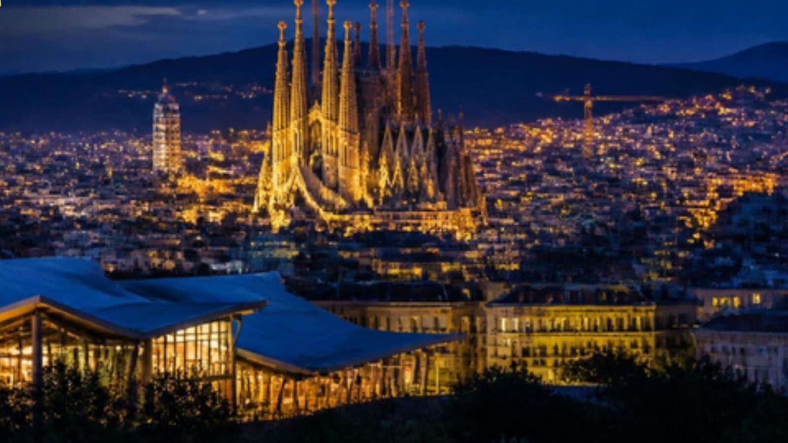 Barcelona at night with the Sagrada Familia lit in gold
